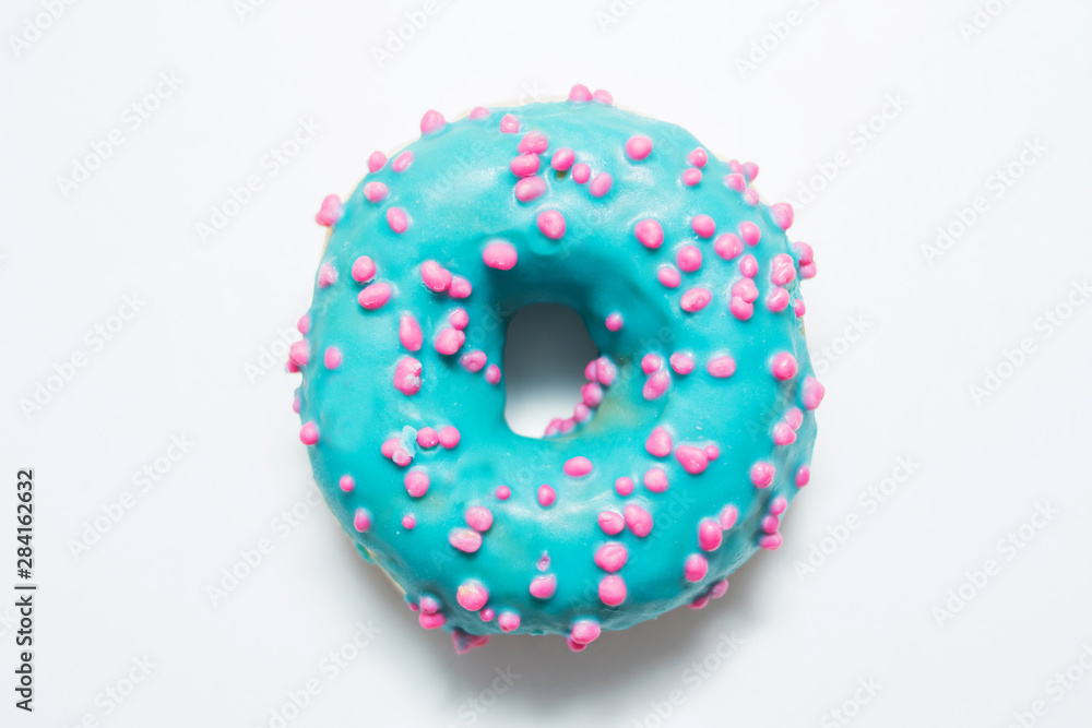 Blue donut with bright sprinkles on a isolated background, food concept