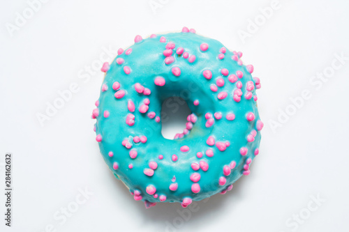 Blue donut with bright sprinkles on a isolated background, food concept