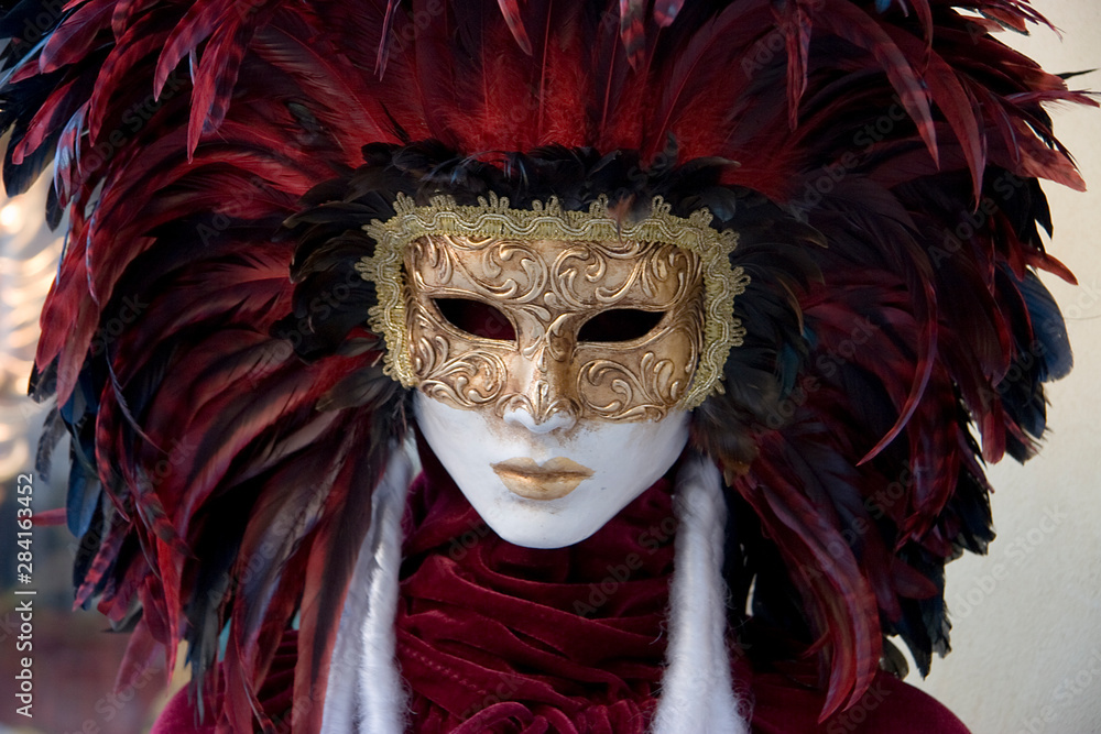 Venice winter mysterious romantic: detail of woman disguised and hidden with venetian mask