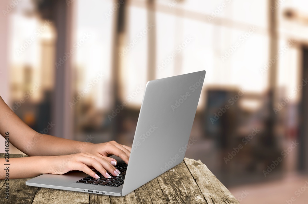 Fototapeta premium Woman Working with Laptop on background, close-up