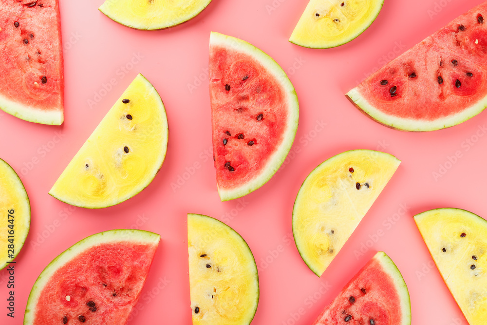 Juicy slices of red and yellow watermelon on a bright pink background. Conceptual colors of summer. Patterns top view as a background or substrate Juicy slices of red and yellow watermelon on a bright pink background. Conceptual colors of summer. Patterns top view as a background or substrate
