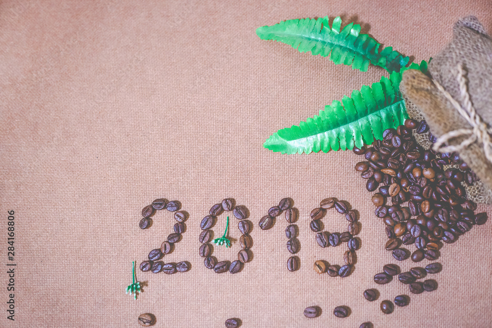 2019 coffee beans on wooden texture in vintage style for new year concept background, coffee new year, merry christmas and happy new year 2019. Copy space.