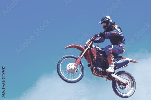 Rider on bike while Motocross race with motion blur background