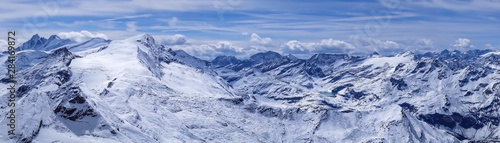 Alpine Austrian mountains covered with snow. Beautiful panorama of high snowy mountains in Austria