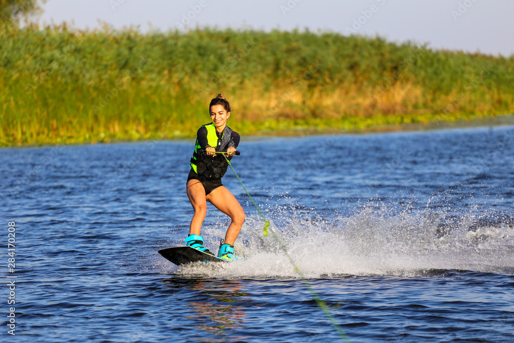 Young Sexy girl Catch waves on wakeboard when boat pulls a wakeboard Young Sexy girl Catch waves on wakeboard when boat pulls a wakeboard