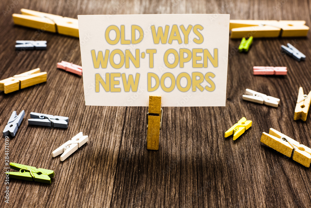 Text sign showing Old Ways Won t not Open New Doors. Conceptual photo be different and unique to Achieve goals Clothespin holding white paper note several clothespins wooden floor