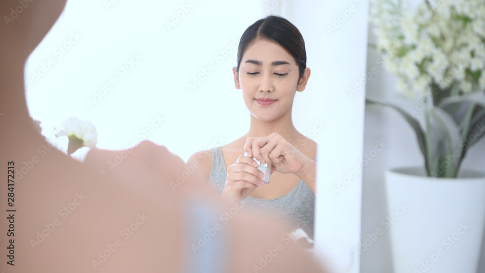 Beauty concept. Reflections in the mirror. Asian girls are applying a facial mask. Beauty concept. Reflections in the mirror. Asian girls are applying a facial mask.
