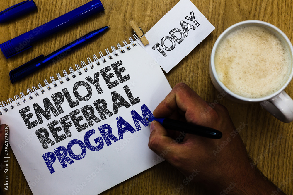 Text sign showing Employee Referral Program. Conceptual photo employees recommend qualified friends relatives Man holding marker notebook clothespin reminder wooden table cup coffee Text sign showing Employee Referral Program. Conceptual photo employees recommend qualified friends relatives Man holding marker notebook clothespin reminder wooden table cup coffee