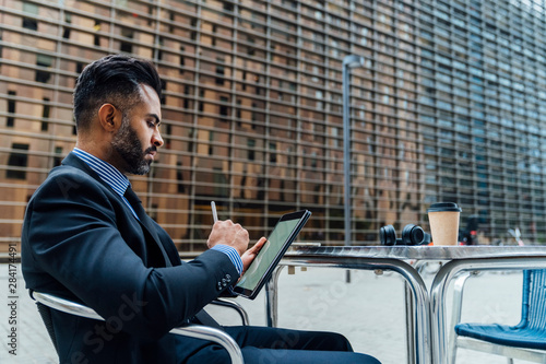 Adult Elegant Indian Businessman Signing a Contract or Taking a photo