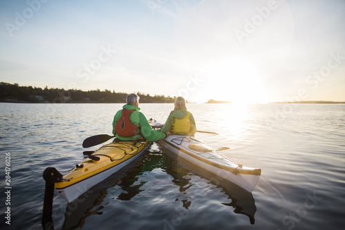 Two people kayaking in the sunshine. photo