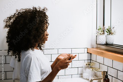 Woman Putting Moisturizer On photo