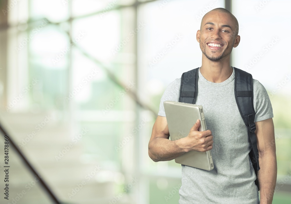 Portrait of smiling young african college student