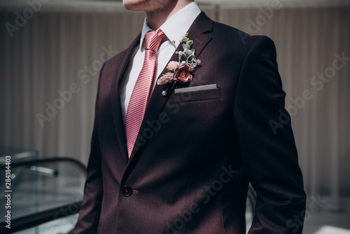 Canvas Print the groom in a suit and tie with a boutonniere