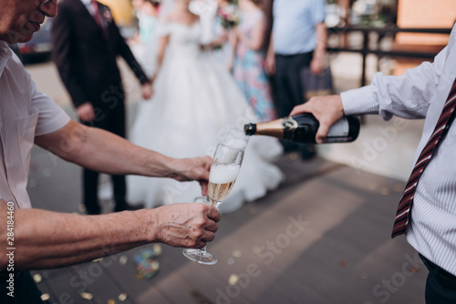 a man pours champagne into a glass