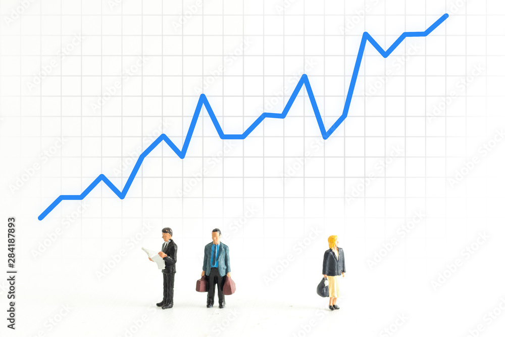 Miniature People Standing Below a Graph Fluctuating up and down Miniature People Standing Below a Graph Fluctuating up and down