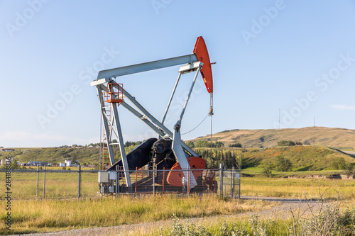 Close up of an oil pumpjack at a farm field. Alberta, Canada. Oil Pump. 