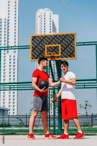 Two young basketball players playing against each other