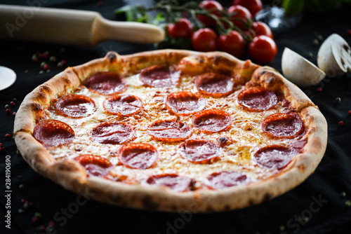 fresh italian pizza diavola with spicy salami, pepperoni & cheese photo