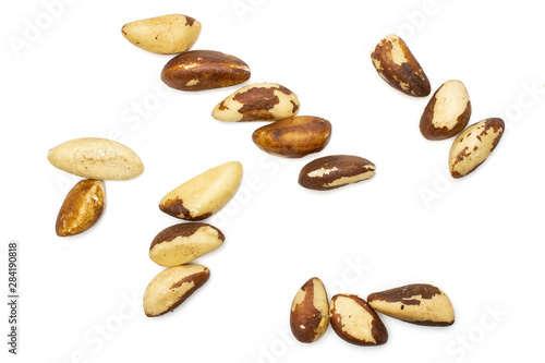 Lot of whole ripe unshelled brazil nut flatlay isolated on white background