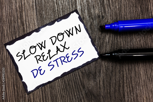 Word writing text Slow Down Relax De Stress. Business concept for Have a break reduce stress levels rest calm Black bordered page with texts laid black and blue pen on wooden floor