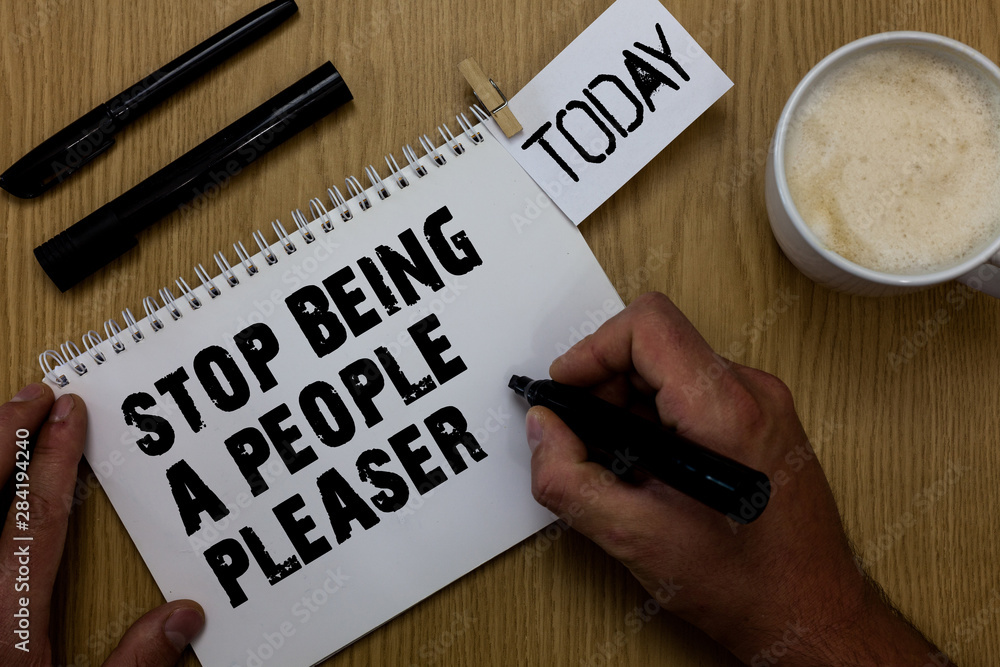 Text sign showing Stop Being A People Pleaser. Conceptual photo Do what you like not things other people want Paperclip retain written notepad hand hold marker coffee black pen on woody desk Text sign showing Stop Being A People Pleaser. Conceptual photo Do what you like not things other people want Paperclip retain written notepad hand hold marker coffee black pen on woody desk