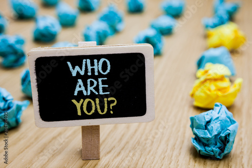 Conceptual hand writing showing Who Are You question. Business photo text Identify yourself description personal characteristics poster board with blurry paper lobs laid serially mid yellow lob photo