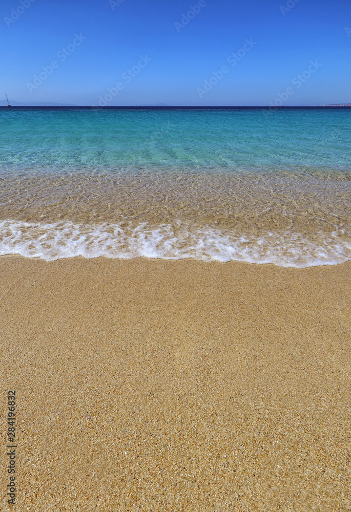 Wave rippling on perfect beach and clear turquoise sea in Agios Prokopios, Naxos, Greek Islands