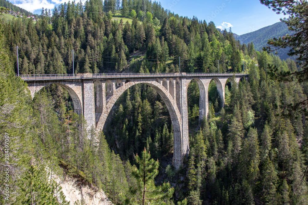 View from the historic Wiesen Viaduct of the Rhaetian Railway near the village Davos Wiesen, Swiss Alps View from the historic Wiesen Viaduct of the Rhaetian Railway near the village Davos Wiesen, Swiss Alps