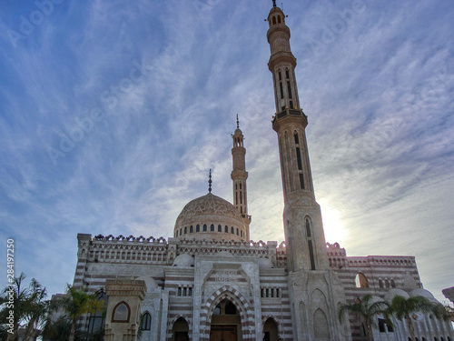 beautiful mosque with minaret lit by sunset, dahab, egypt