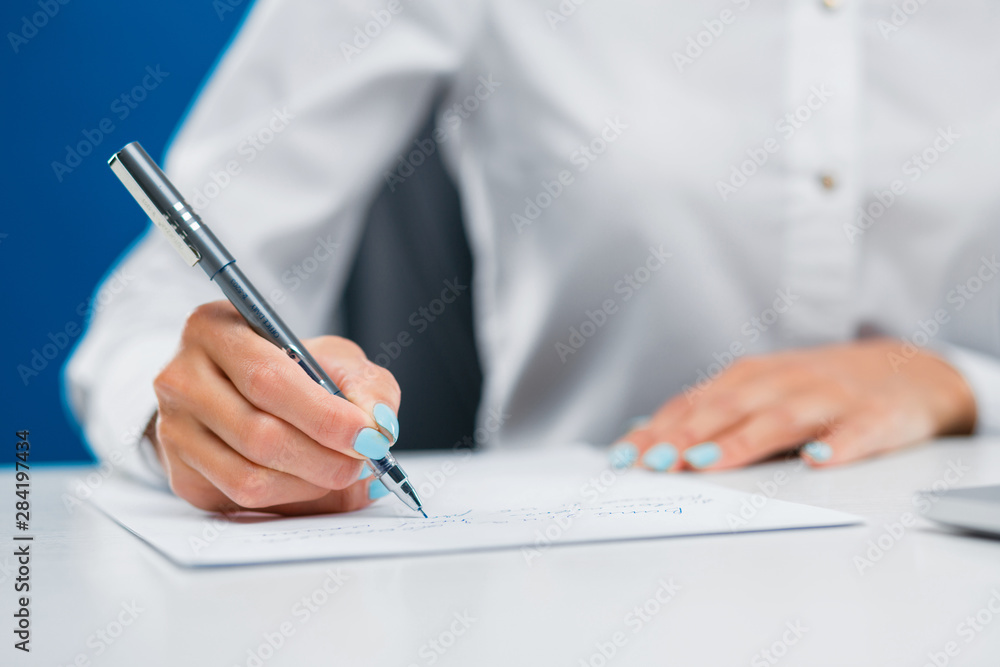 Businesswoman writing down on a sheet of paper new ideas. Businesswoman writing down on a sheet of paper new ideas.