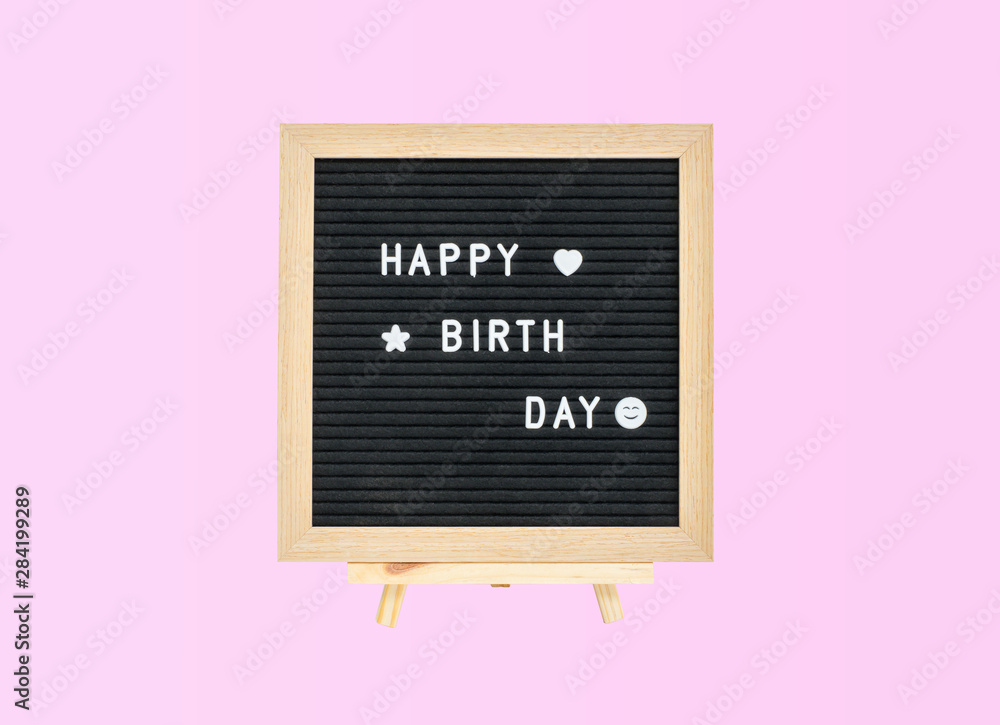 Fototapeta Closeup a board with happy birth day word isolated on pink background