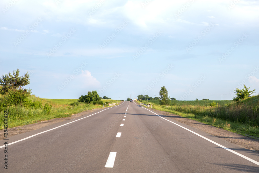 speed highway through the field. asphalt-paved road
