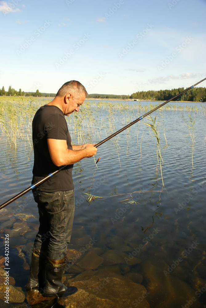Fisherman and fishing rod on the river Fisherman and fishing rod on the river