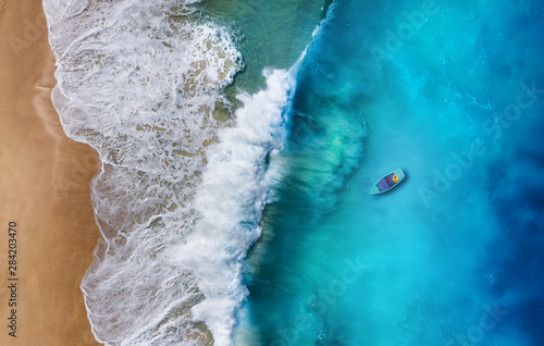 Boat on the water surface from top view. Turquoise water background from top view. Summer seascape from air. Travel - image