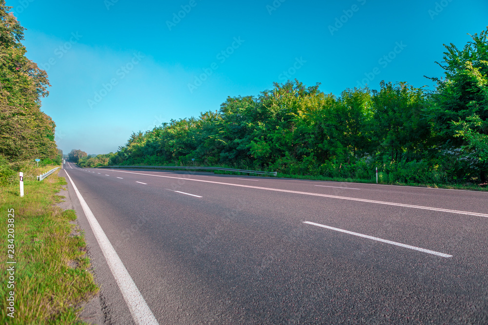 Asphalt highways and mountains under the blue sky