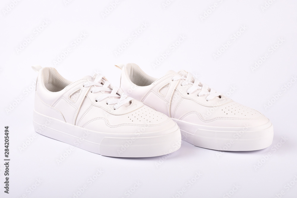 A pair of white sneakers on the white background A pair of white sneakers on the white background