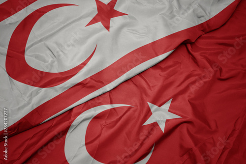 Billede på lærred waving colorful flag of turkey and national flag of northern cyprus