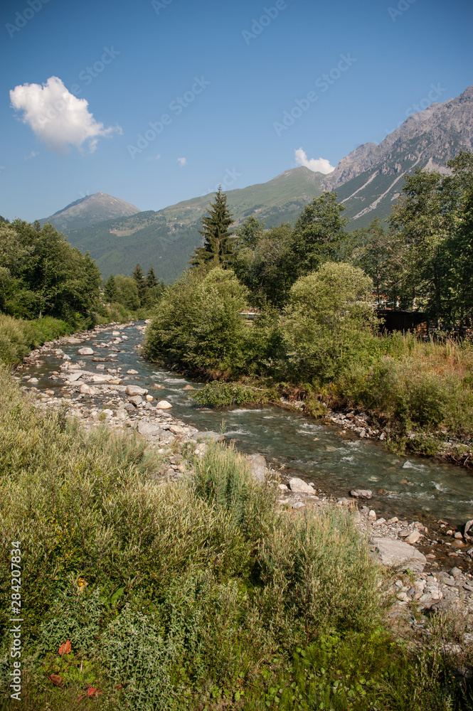Panorama with mountain river in Italian Alps in summer day Panorama with mountain river in Italian Alps in summer day