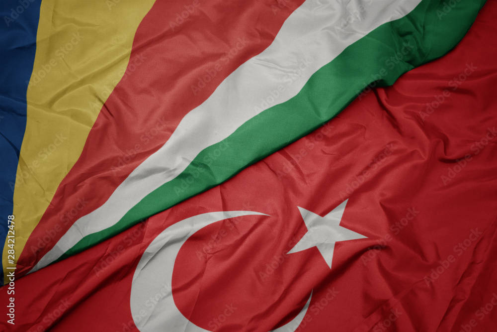 waving colorful flag of turkey and national flag of seychelles.