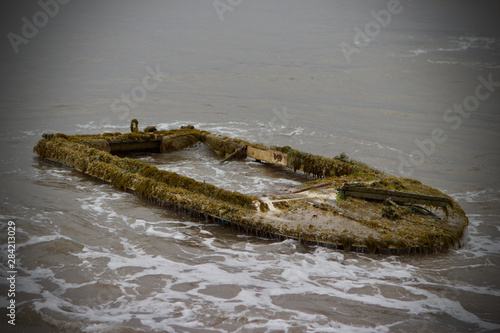 small boat shipwrecked on beach