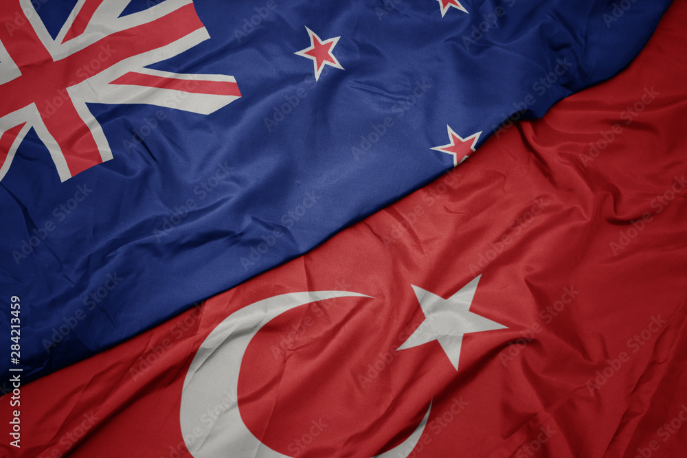 waving colorful flag of turkey and national flag of new zealand. waving colorful flag of turkey and national flag of new zealand.