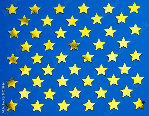 Fifty golden glowing stars on a blue background. Part of the flag of USA