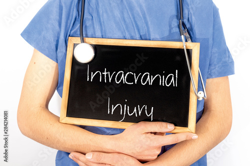 Doctor shows information on blackboard: intracranial injury.  Medical concept. photo