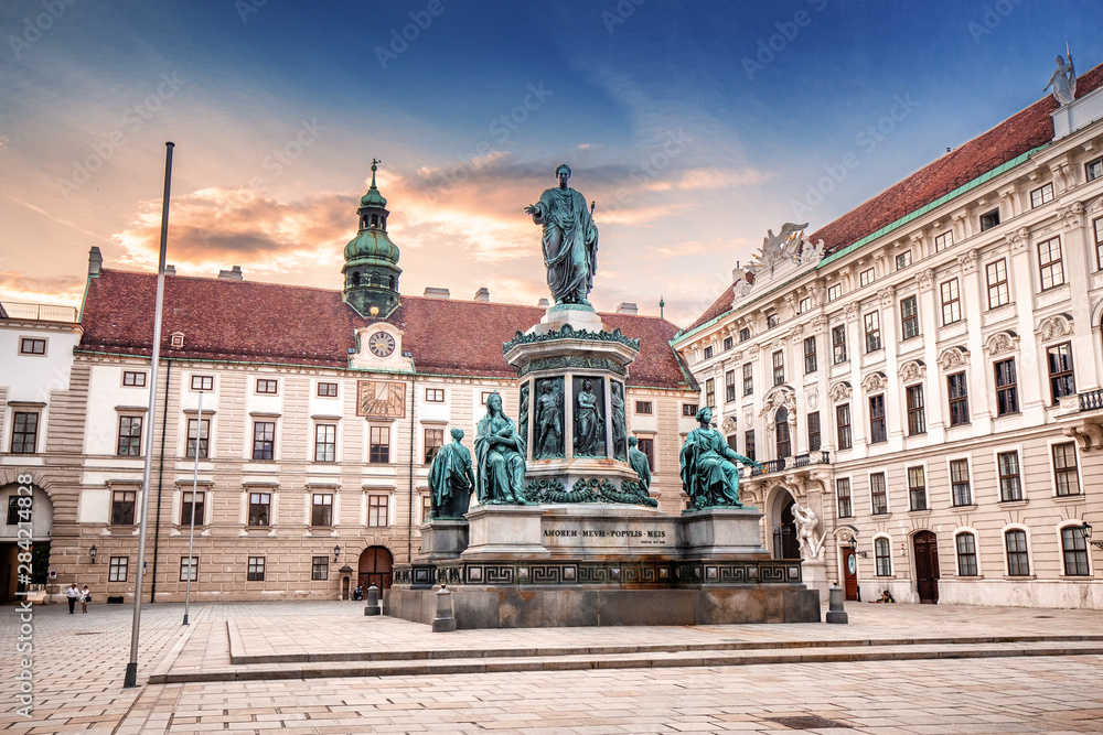 Sunset cityscape view with Statue of Kaiser Franz I in the courtyard of imperial Hofburg Palace in Vienna, Austria