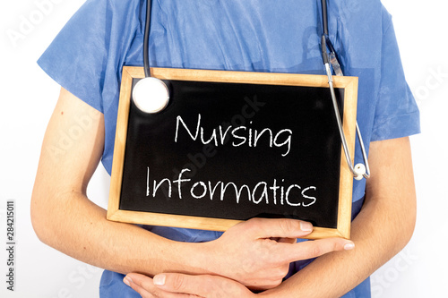 Doctor shows information on blackboard: nursing informatics.  Medical concept.