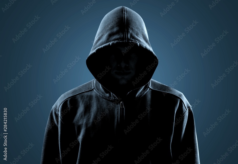 Thief in black clothes on grey background