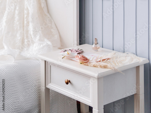 Fotografie Gray bedside table with bridal accessories