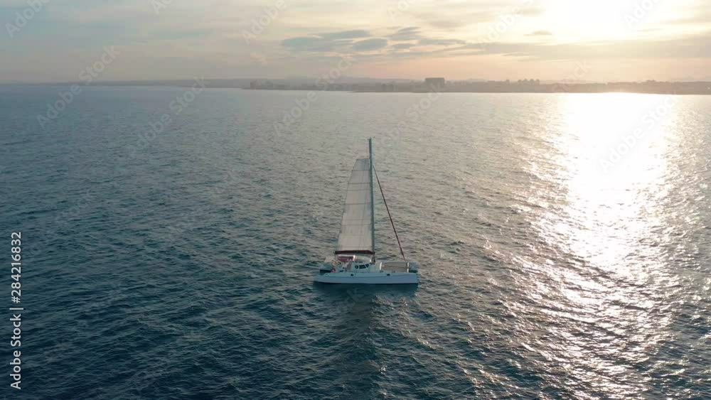 Catamaran sailing on the sea. Aerial shoot of the Catamaran sailing in the wind. Catamaran sailing on the sea. Aerial shoot of the Catamaran sailing in the wind.