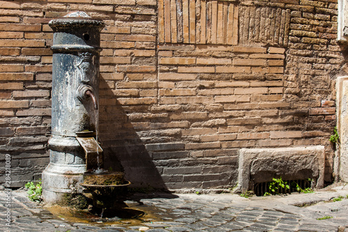 Fototapeta Naklejka Na Ścianę i Meble -  Typical antique public drinking fountain on the streets of Rome