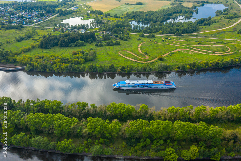 The Volga River, Russia. Tourist steamer floating on the Volga river channel, view from the quadcopter